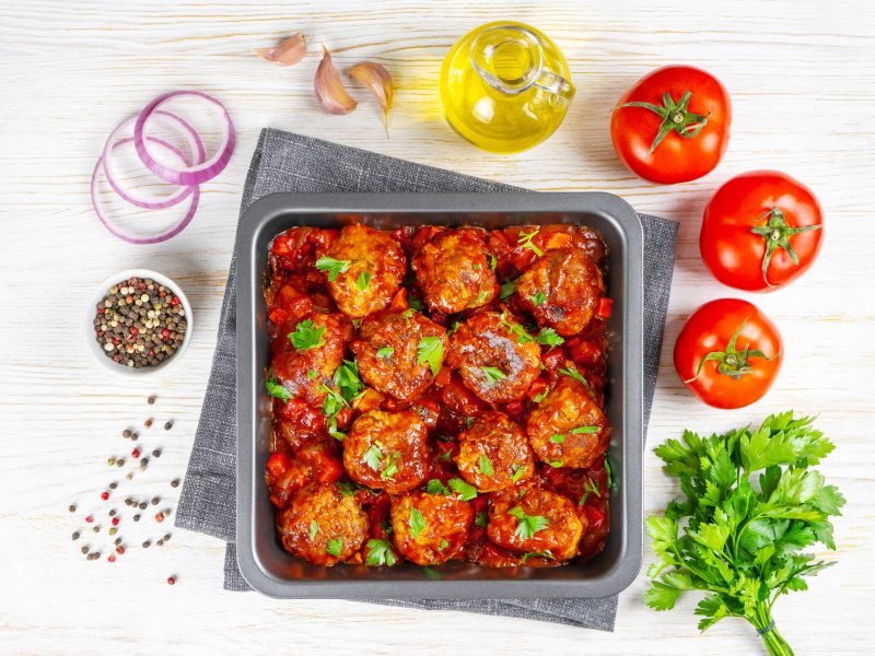 Homemade meatballs with tomato sauce and spices served in black